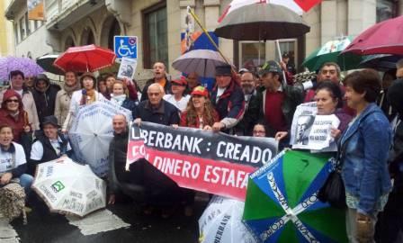 Afectados por las preferentes de Liberbank se manifiestan contra el banco.