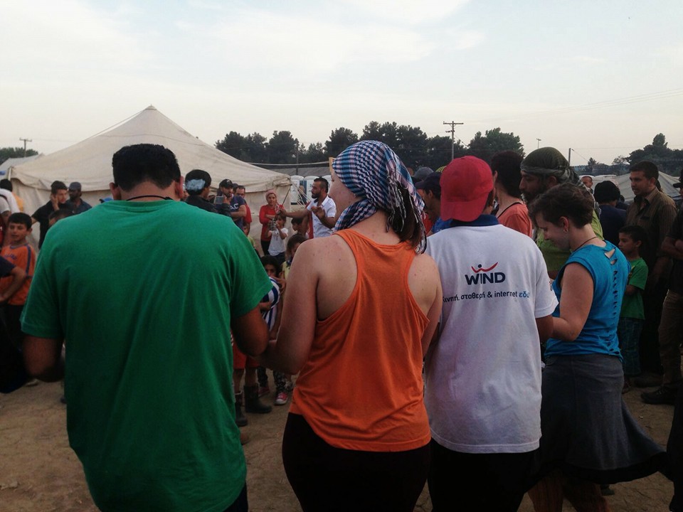 Marina (derecha) bailando con varios voluntarios y refugiados en el campamento de Idomeni.